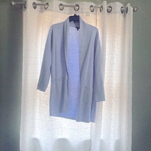 Stylish long powder blue sweater.  Pockets on each side on the front